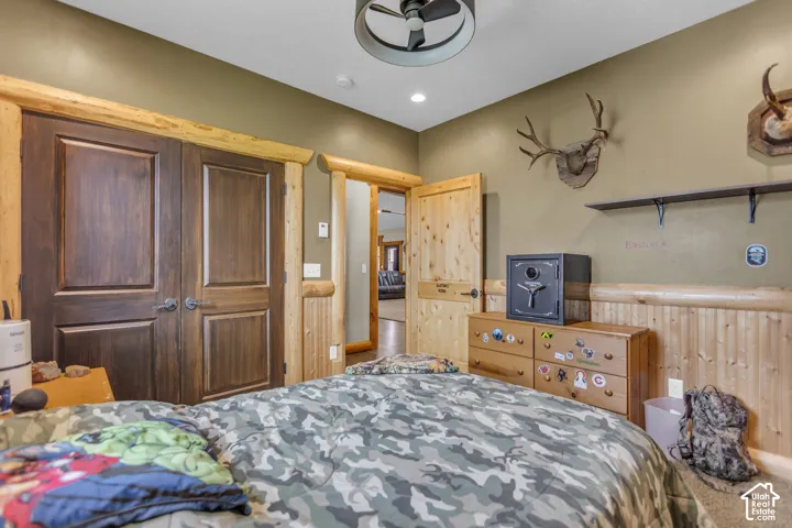 Dual paneled wood doors, rustic wood trim, natural wood wainscoting, ceiling fan light fixture, recessed lighting