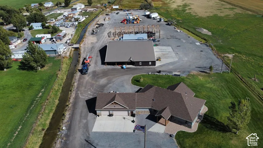 Asphalt shingle roof residence with an attached garage, paver stone walkway, and a gravel driveway
