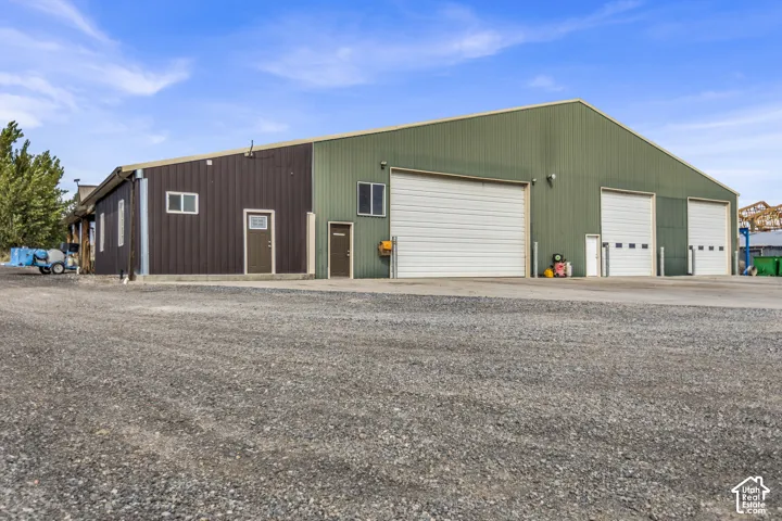 Metal-sided commercial building with a gravel lot