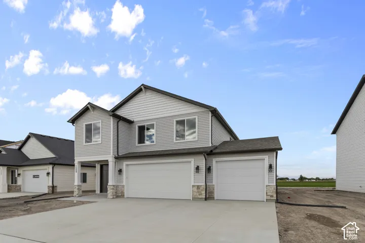 Two-story dwelling with light grey siding and dark trim