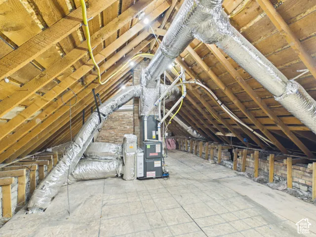 Exposed wood rafter system, brick chimney, engineered wood flooring, and HVAC ductwork and units