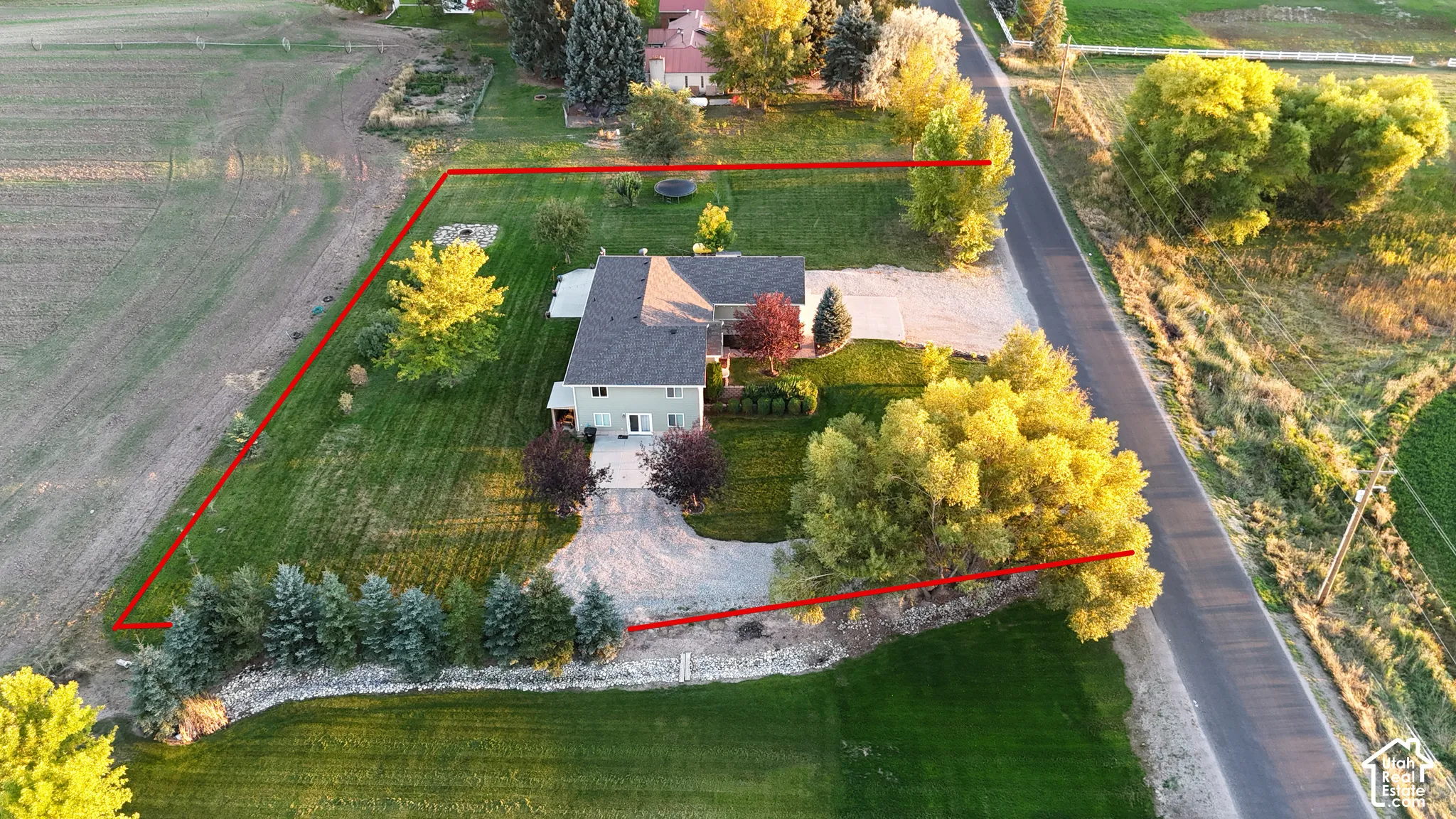 Expansive green lawn bordering agricultural fields