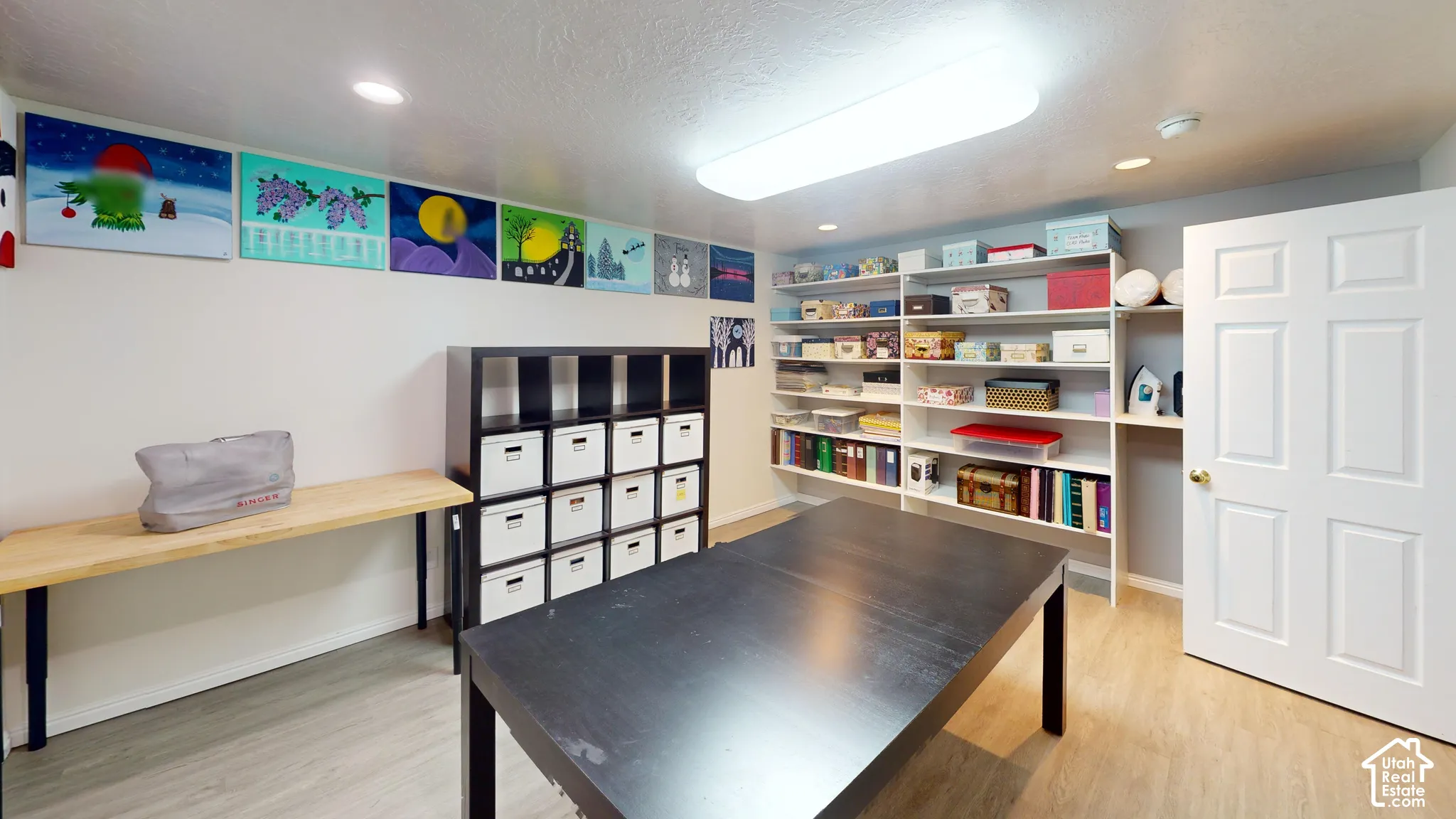 Versatile room with wood-finish flooring, recessed lighting, and a six-panel door