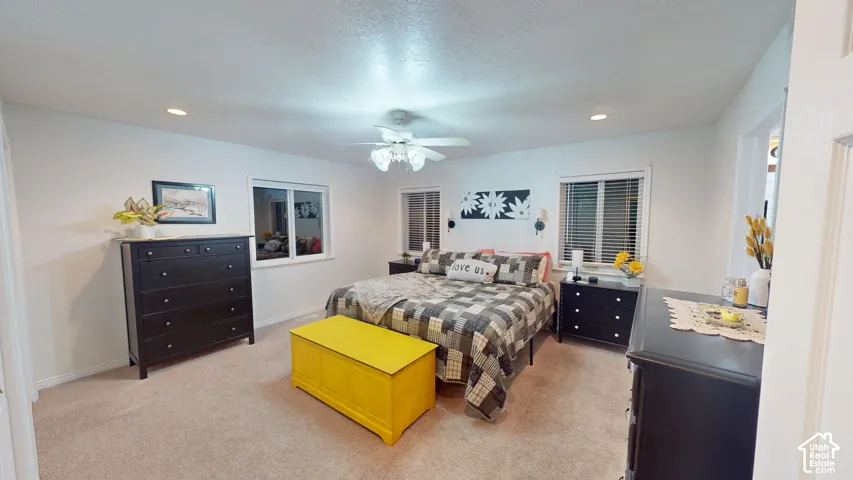 Recessed lighting, ceiling fan, and carpeted flooring