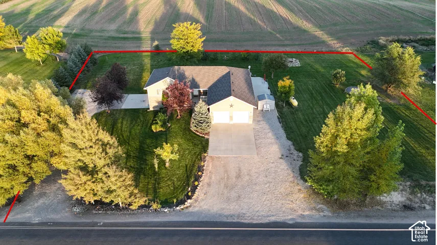 Single-story residence with a two-car garage, concrete driveway, and expansive lawn area