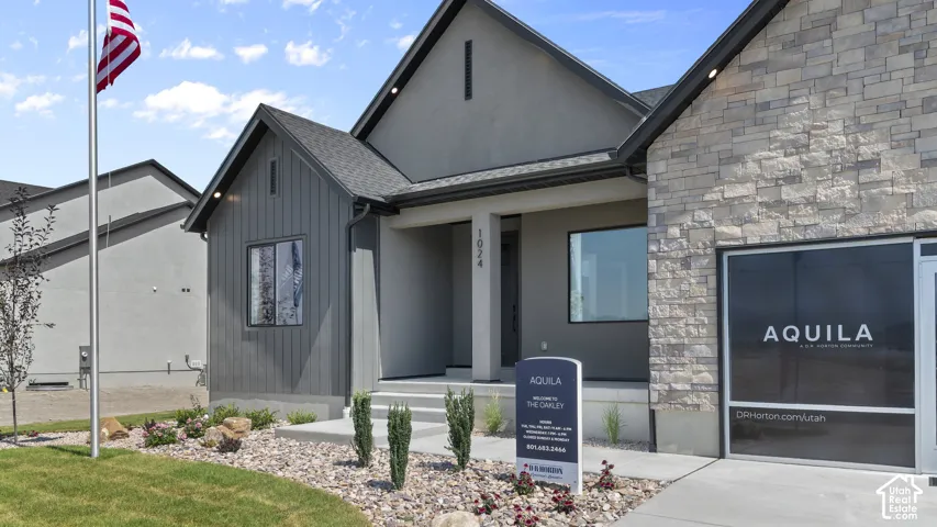 Contemporary exterior featuring stone veneer, stucco, and vertical siding accents