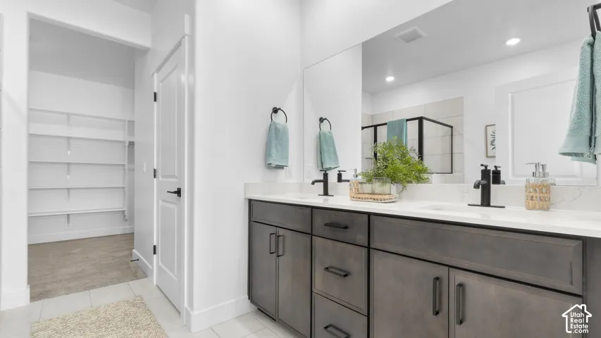 Dual vanity with integrated sinks, matte black fixtures, and a large wall-mounted mirror