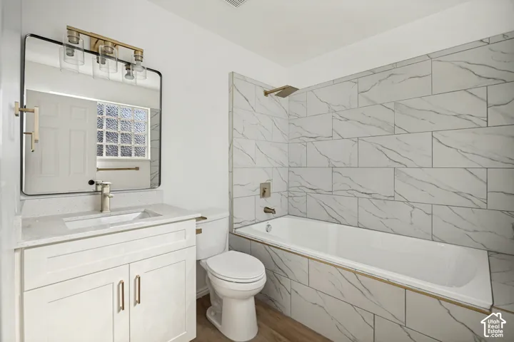 White vanity with integrated sink and brushed nickel faucet