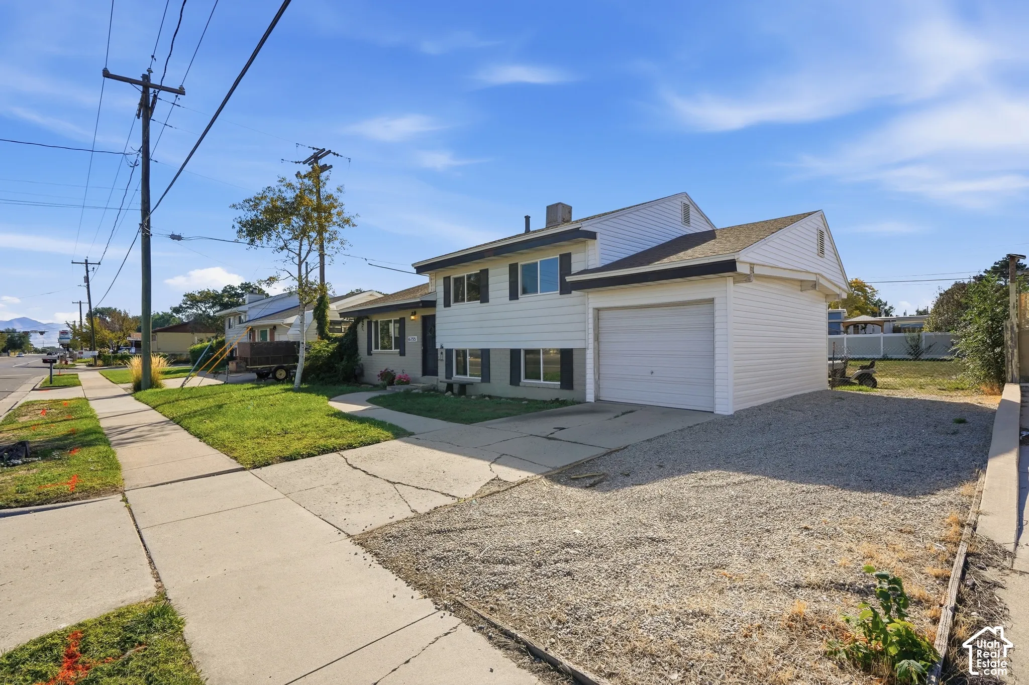 White siding exterior with black shutters and an attached garage