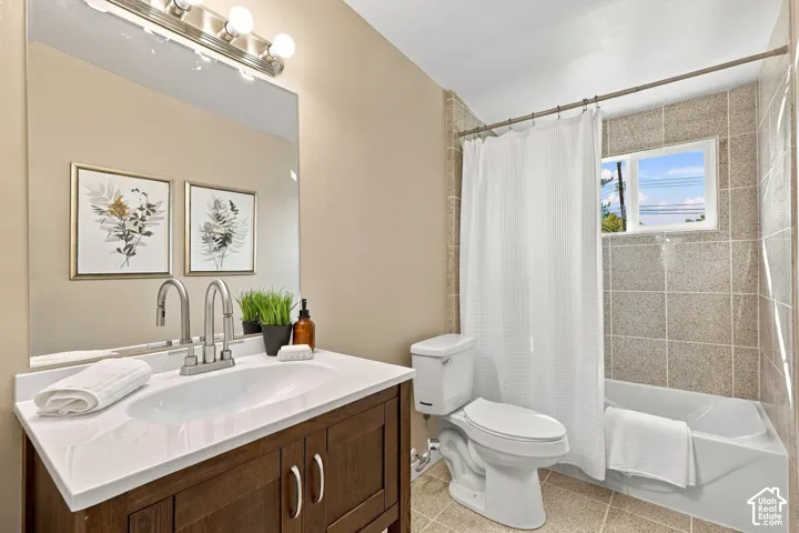 Full vanity with integrated sink, brushed nickel faucet, large mirror, and overhead vanity lighting