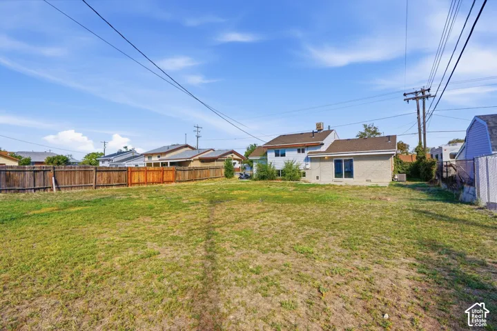 Expansive grassy lot with wood fencing