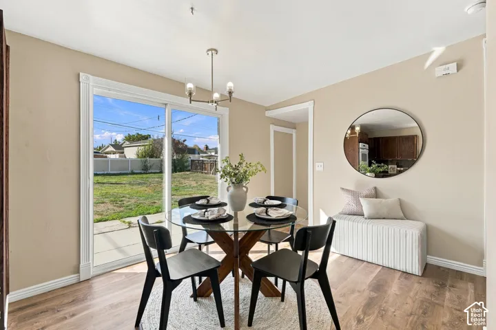 Wood-finish flooring, sliding glass doors, neutral wall paint, and a built-in light fixture