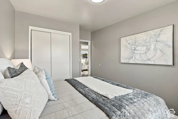 Recessed ceiling lighting, light gray wall paint, sliding closet doors, and white trim