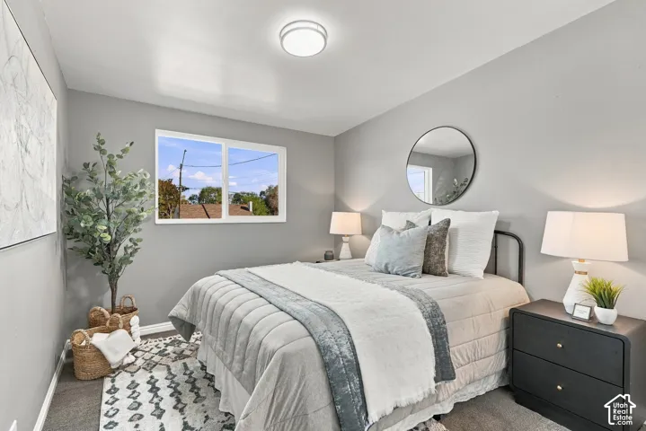 Recessed lighting, wall-mounted circular mirror, window with white framing, and carpet flooring