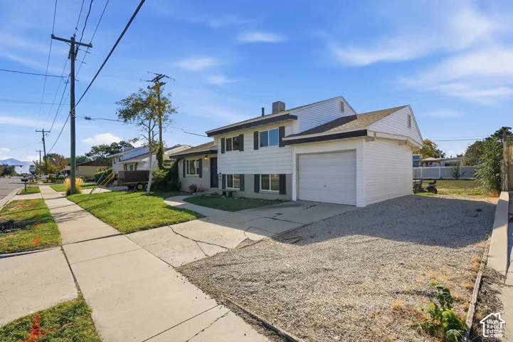 White siding exterior with black shutters and an attached garage