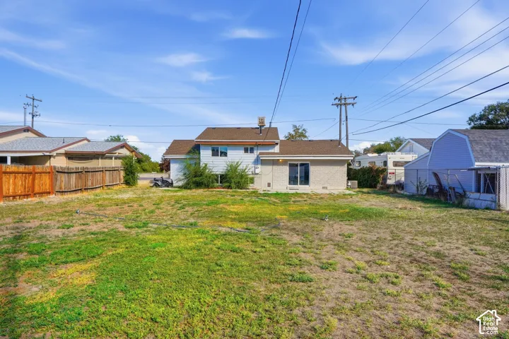 Spacious backyard with a partial wood fence