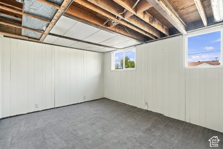 White paneled walls and a gray carpeted floor