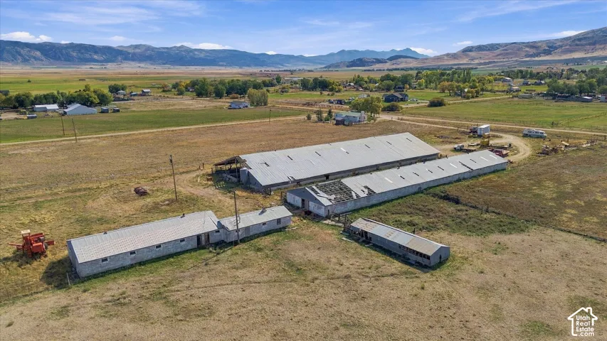 Multiple agricultural buildings featuring metal roofs and extensive land area