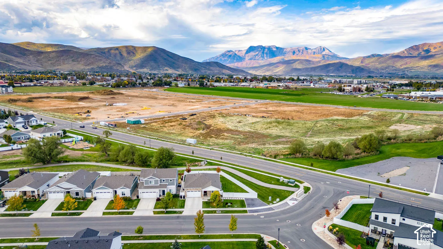 Mountain backdrop with residential properties and open land