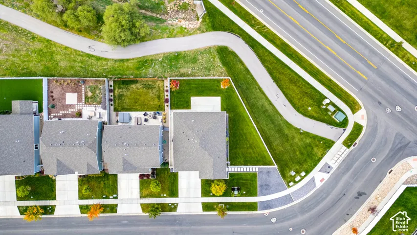 Residential neighborhood featuring a paved walking path, mature trees, manicured lawns, and well-maintained roadways