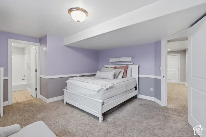 Carpeted flooring, recessed ceiling beam, flush-mount ceiling light fixture, two-tone wall paint, white trim