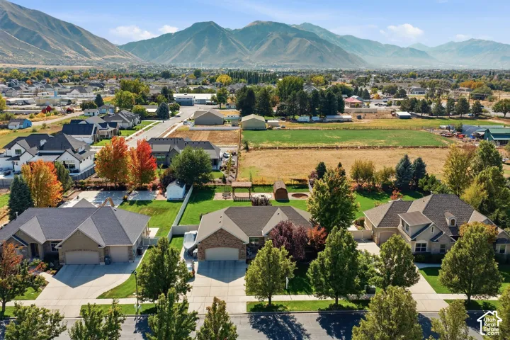 Mountain backdrop, residential neighborhood, varied rooflines, mature landscaping, paved streets