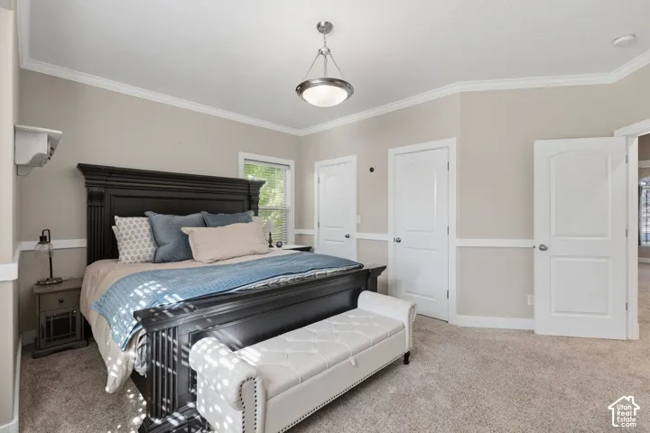 Spacious room featuring neutral wall tones, crown molding, chair rail detailing, recessed windows, and textured carpeting