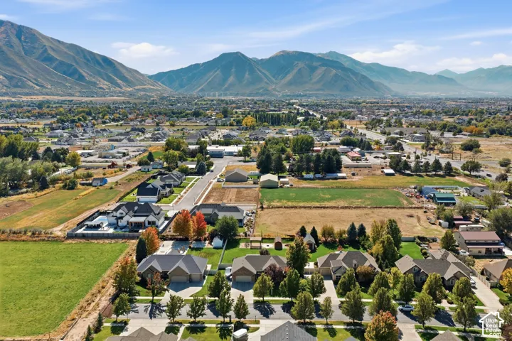 Expansive mountain backdrop with a residential area and agricultural land