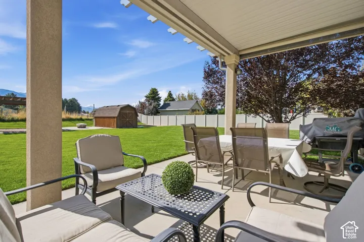 Covered concrete patio with a solid roof and a decorative pergola extension