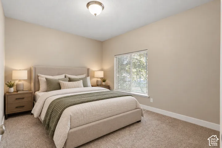 Neutral wall color, carpet flooring, window with blinds, and flush mount lighting