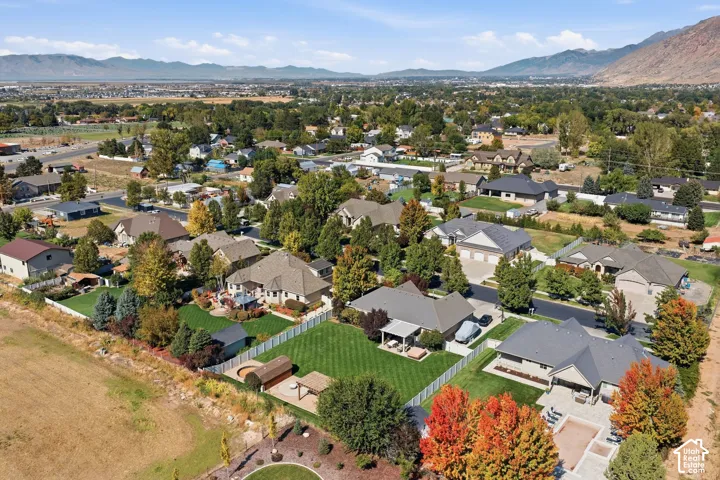 Expansive neighborhood setting featuring a variety of architectural styles, mature landscaping, and mountainous backdrop