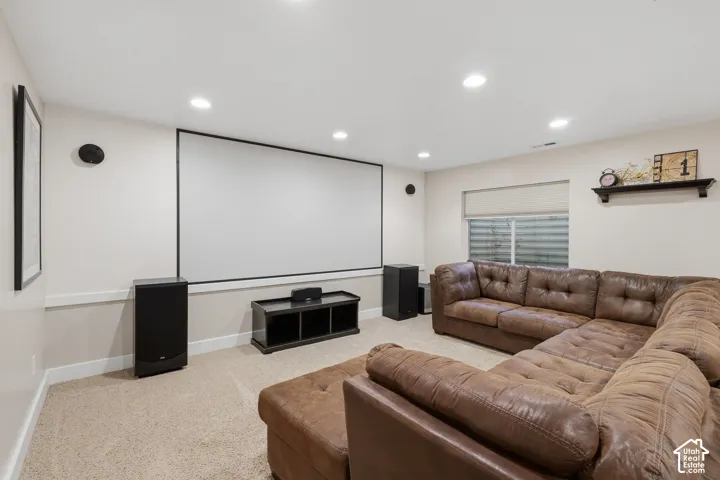 Media room featuring a large projection screen and recessed lighting