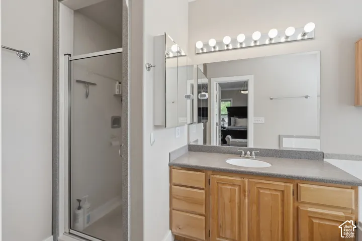 Glass-enclosed shower with chrome fixtures