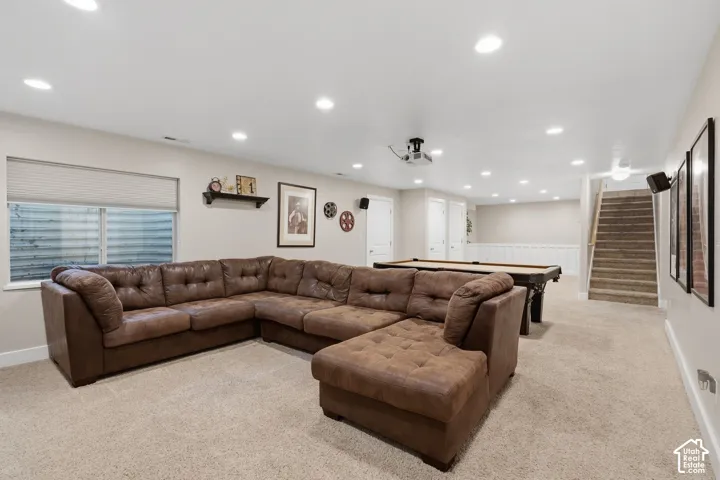 Recessed ceiling lighting, durable carpeting, built-in window, and wood-finish stair railing