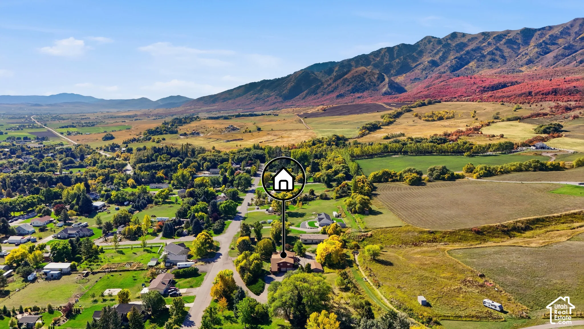 Expansive mountain range backdrop and surrounding rural landscape