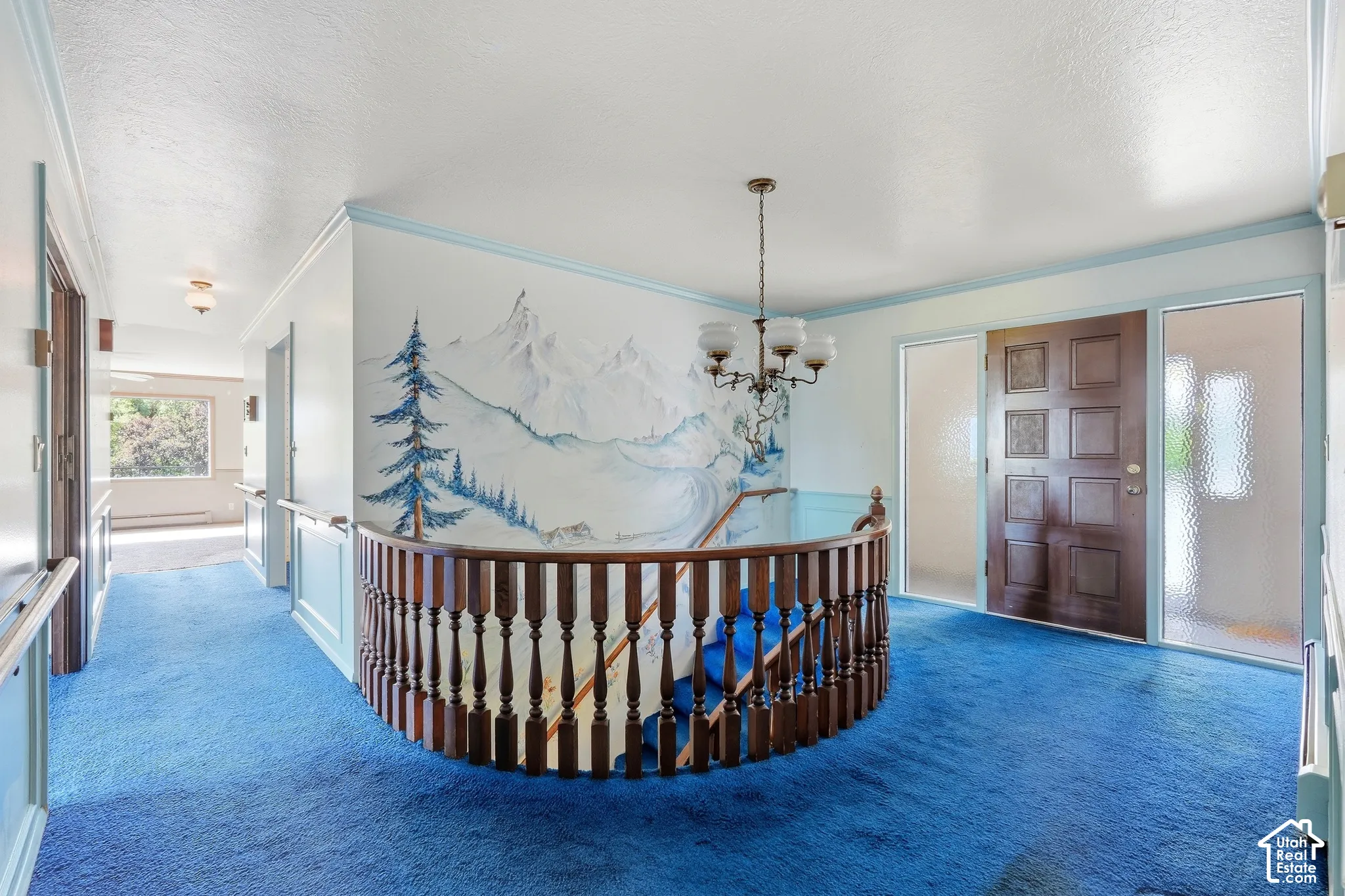 Entryway featuring a paneled wood door, frosted glass sidelights, and a chandelier