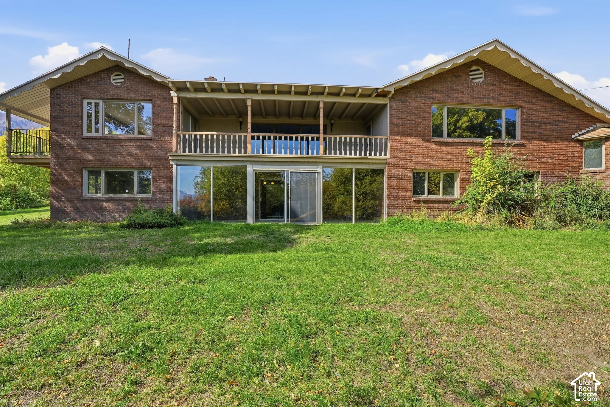 Brick exterior with a covered upper-level balcony