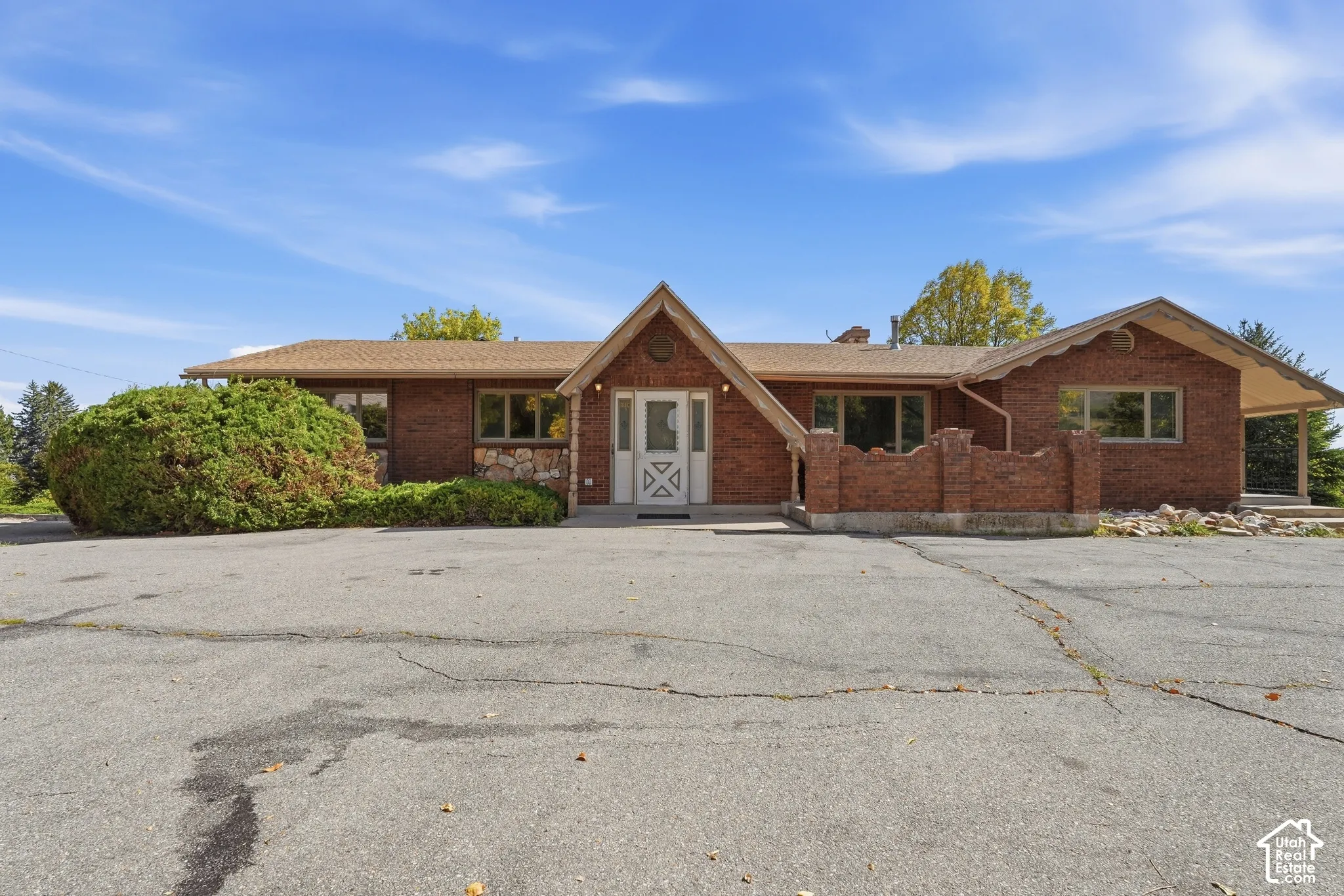 Brick exterior with stone accents, a gabled entry, and an attached covered porch