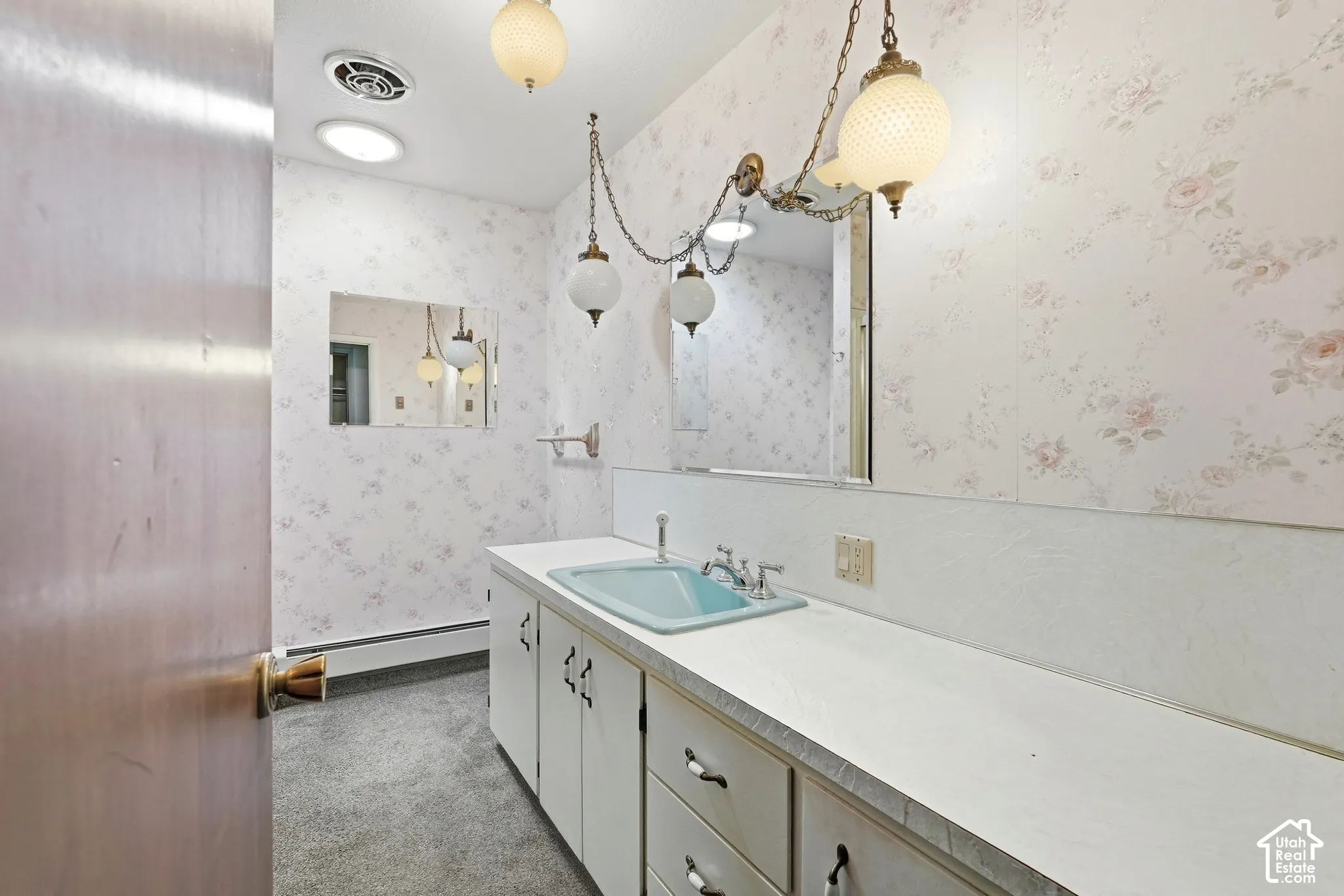 Extended vanity with an integrated sink and base cabinetry