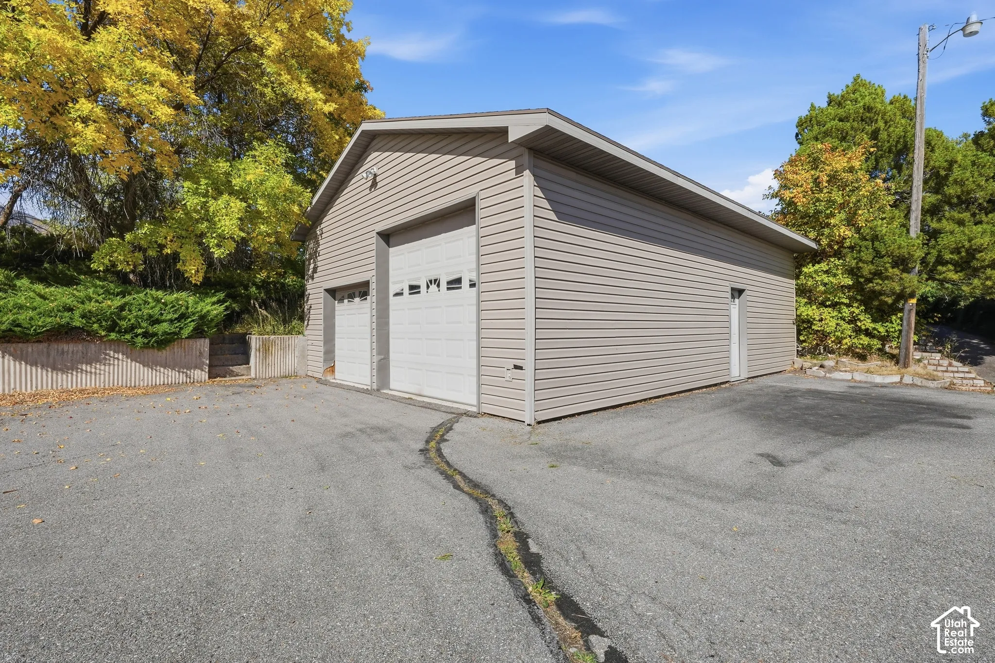 Two-car garage with an additional single-car garage, featuring horizontal siding
