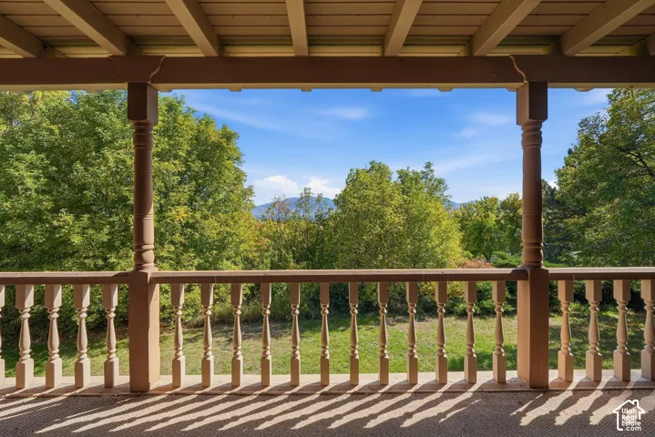 Covered porch with wood balustrade and support columns