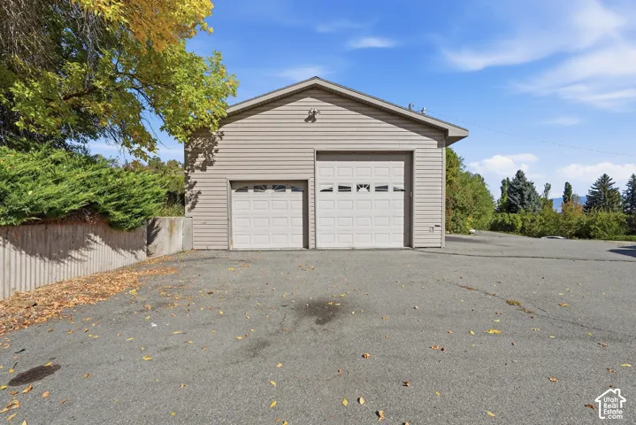 Detached two-car garage with vinyl siding and two overhead doors