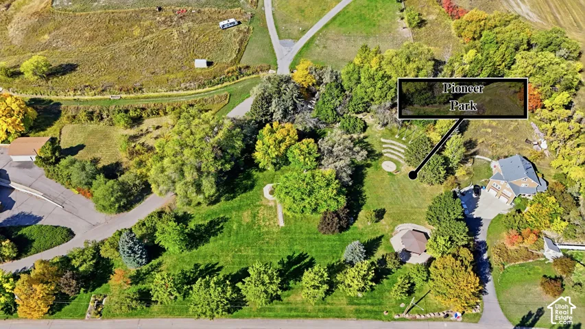Aerial perspective showcasing extensive green spaces, mature trees, and paved roadways