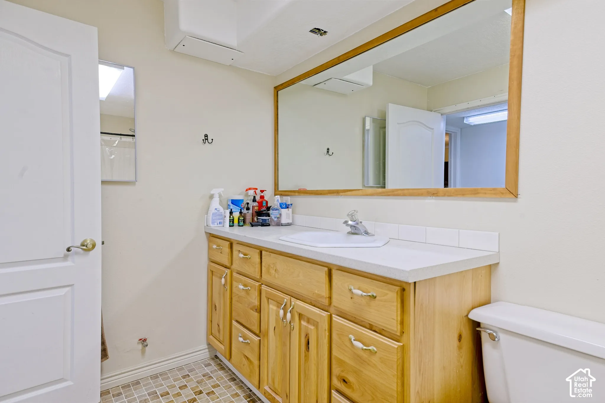 Wood-finish vanity with an integrated sink and light-toned countertop
