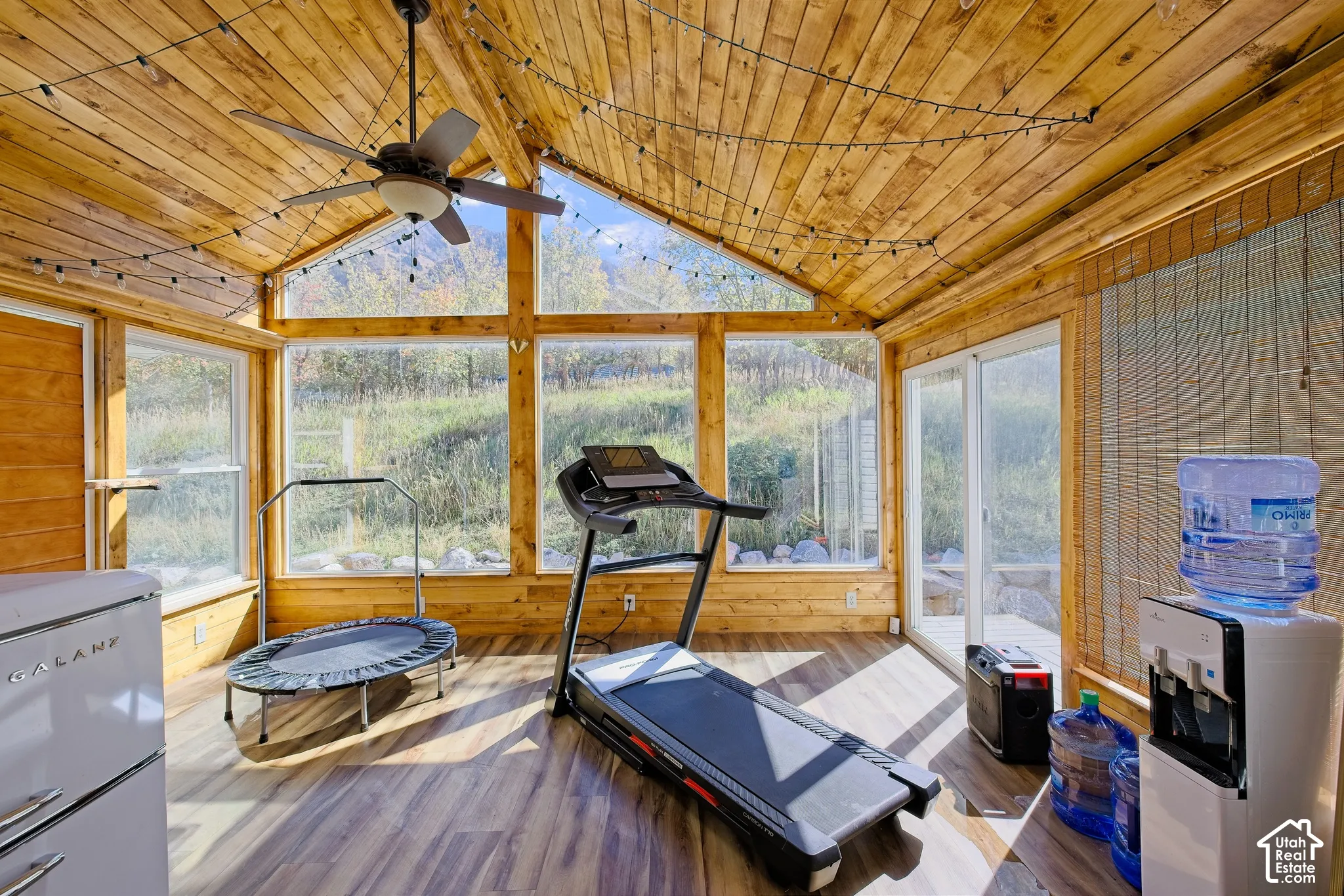 Vaulted wood-paneled ceiling with an attached ceiling fan