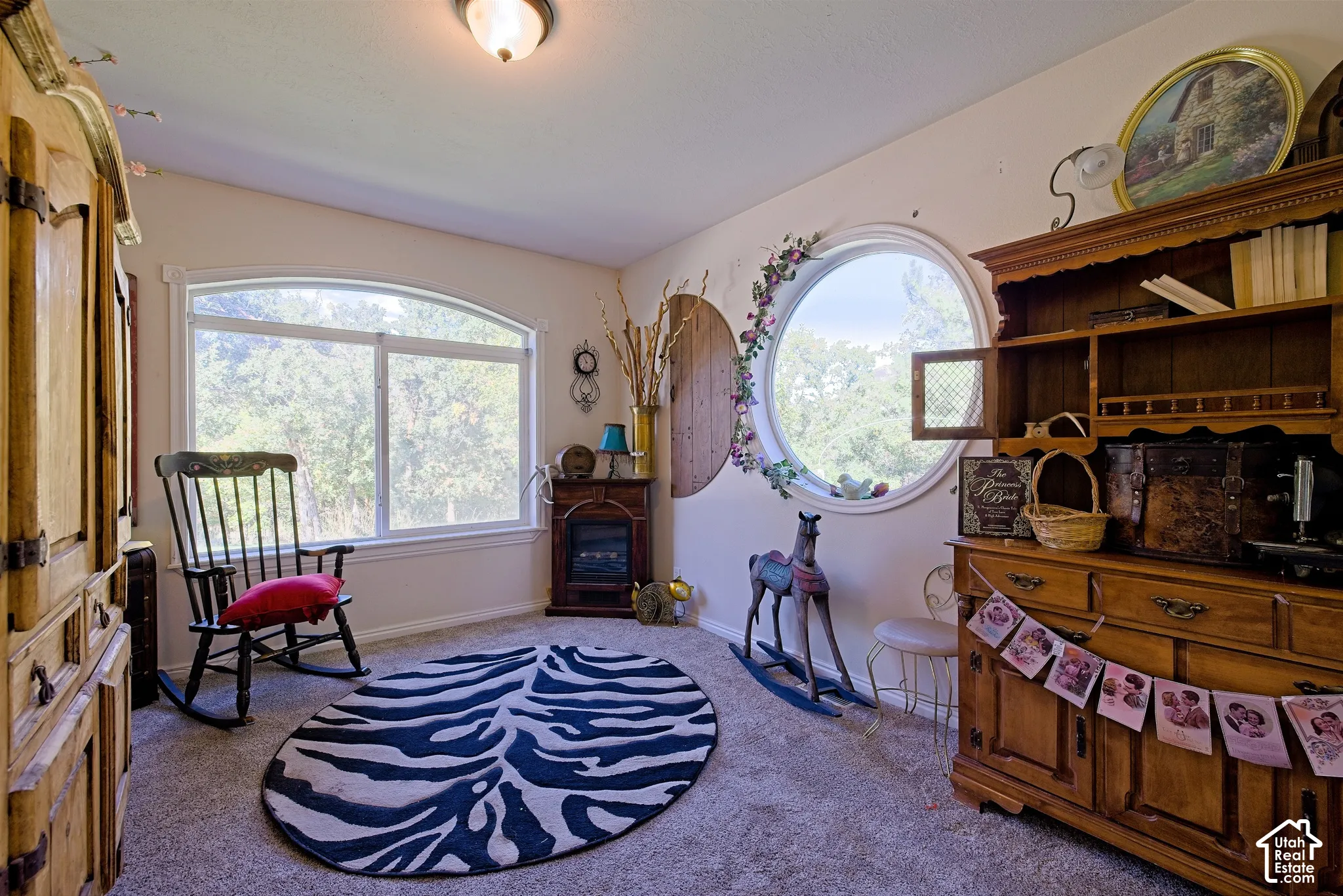 Arched window, circular window, built-in shelving, wood-finish cabinetry, recessed ceiling light