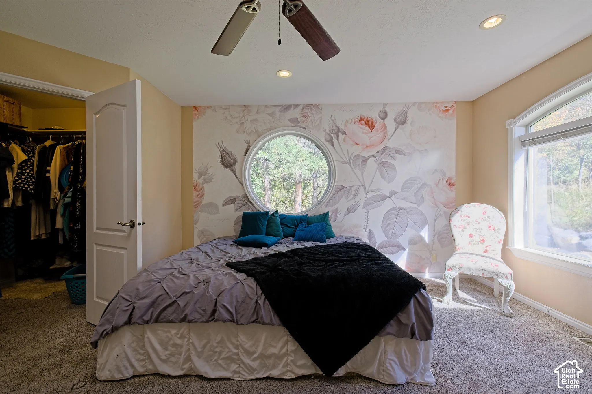 Recessed lighting, ceiling fan, arched window, round window, and a built-in closet with shelving and hanging rods