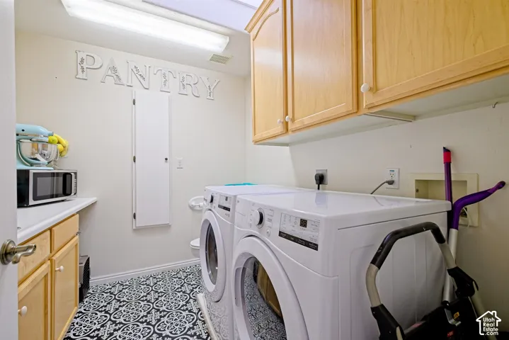 Built-in cabinetry, white countertop, patterned floor tiling, and overhead lighting
