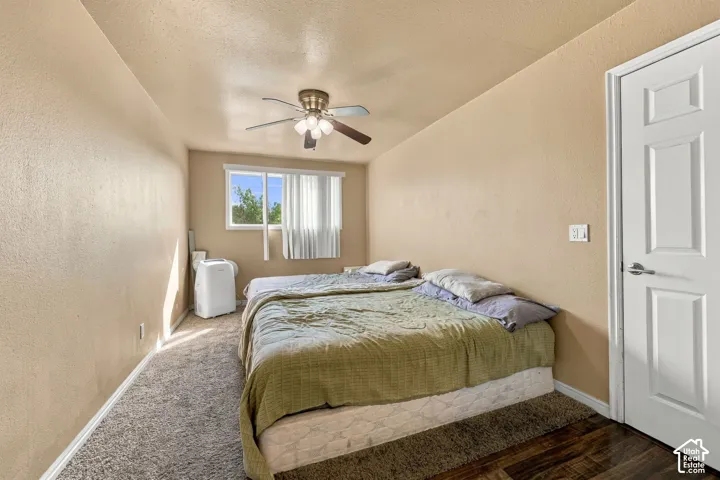 Recessed window with white trim, ceiling fan with integrated lighting, and a paneled door