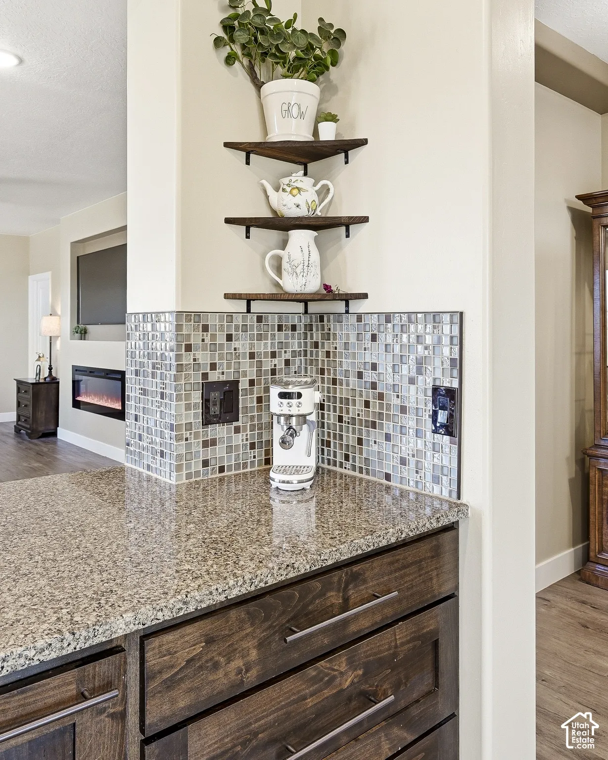 Granite countertop with a mosaic tile backsplash